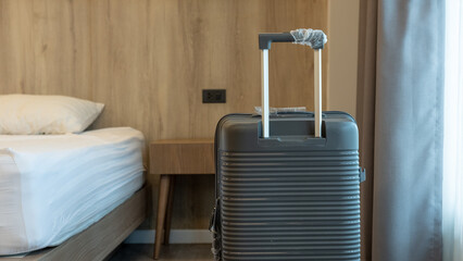 Spacious suitcase set near the bed in a bright room, reflecting preparation for an upcoming trip