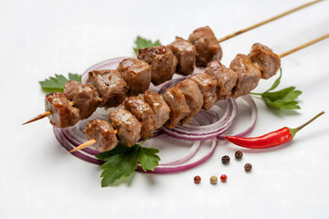 Grilled Meat Skewers with Onion Rings and Chili Pepper on White Background