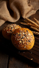 Artisan seeded bread rolls on rustic wooden surface with burlap