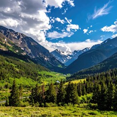 Mountain valley vista, vibrant greens and a clear blue sky. Lush valley floor, dotted with trees,  meanders into a dramatic mountain range