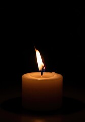 A flickering candlelight flame provides warmth, comfort, and soothing ambiance during darkness, symbolizing hope, remembrance, and quiet meditation ,soft ,quiet ,burning