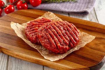 Raw uncoocked red beef round cutlet