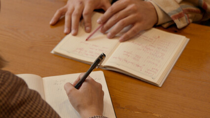 Close-up of hands signing a document during a serious business consultation