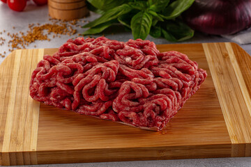 Raw minced beef meat over board