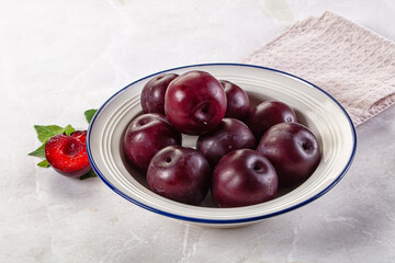 Raw ripe purple plum heap