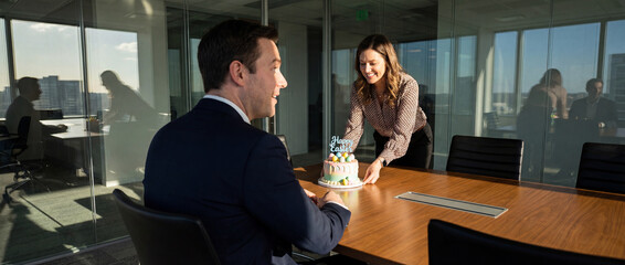 Celebration in the office with a man and a woman at a table