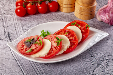 Italian caprese salad with mozzarella, tomato and basil