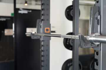 Sports gym interior (power rack, barbell)
