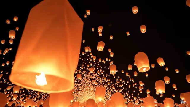 Sky Lanterns Floating Upward at Night During a Festival Celebration