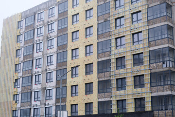 Residential building exterior under construction with facade insulation