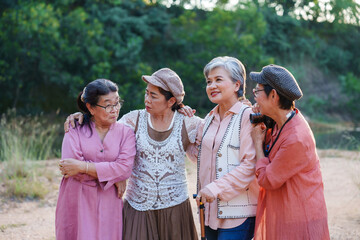 Senior Asian women embracing smiling cheerful outdoor relaxing friendship nature adventure freedom travel casual clothing lifestyle leisure happiness journey bonding togetherness sightseeing
