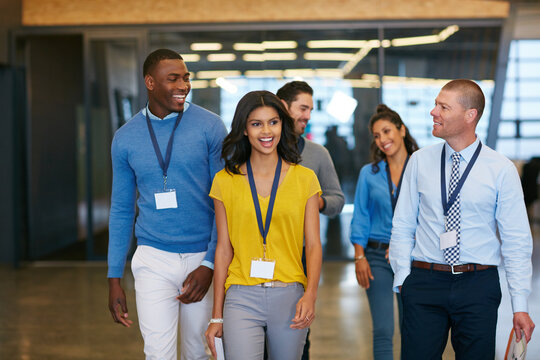 Business, people and walk with smile in office for planning, press conference or media coverage. Journalist, team and happiness with ID badge for seminar, interview preparation and tradeshow event