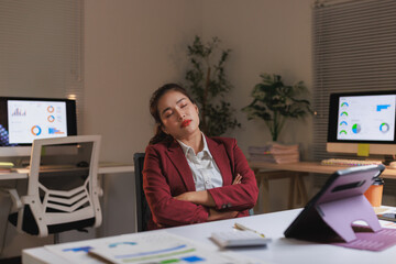 Businesswoman sleeping at office desk during late night work