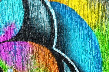 Naklejka premium Graffiti artwork featuring neon blue, pink, yellow, textured surface. 90s, acid style, vibrant colors, dynamic shapes. Street art, urban murals, creative backgrounds, modern 90s visuals.