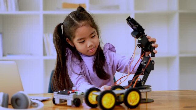 Young innovator assembles robot home workspace educational activity creative environment close-up view stem learning journey