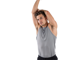 Man stretching arm overhead in workout gear in bright setting during indoor fitness session