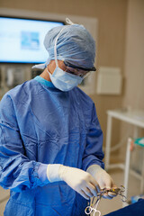 Healthcare, preparation and surgical scissors with doctor in operating room for procedure....