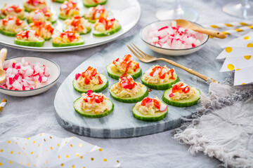Healthy party snack with cucumber and tuna spread, garnished with radish