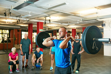 Barbell, fitness and man in gym as coach for workout, strength training or exercise with group....