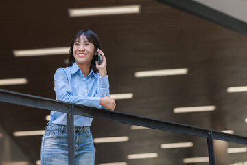 Young asian woman smiling using smartphone talking