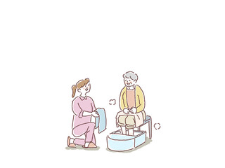 足湯をする高齢女性とタオルを差し出す、看護師、介護士、ヘルパーの女性