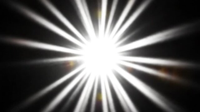 Bright white light radiating outwards from the center on a black background, starburst effect animation