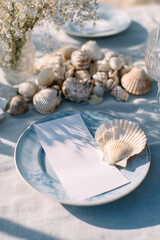 Beach wedding table setting with blank menu and coastal decor