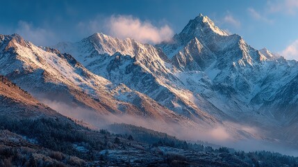 Obraz premium Snow-capped mountain peaks and foggy forest under morning light magnificent natural mountain landscape 