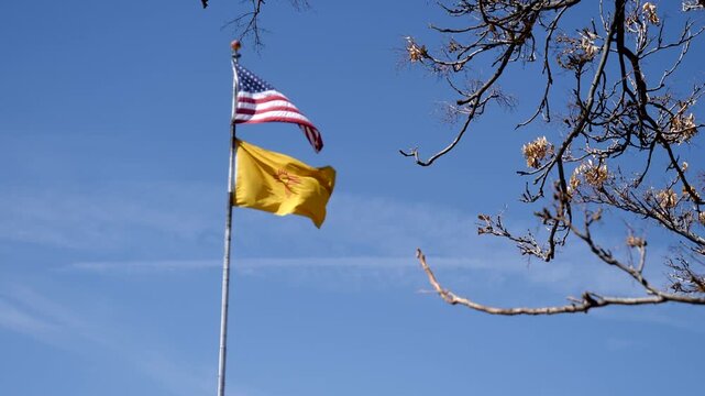 An American flag and a New Mexico state flag fly in historic Santa Fe, New Mexico
