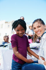 Volunteer doctor, woman and child for social responsibility, portrait or injection for wellness at...
