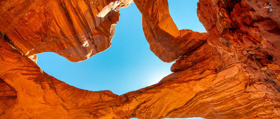 Scenic view of Double Arch red sandstone rocks under clear blue sky in Arches National Park