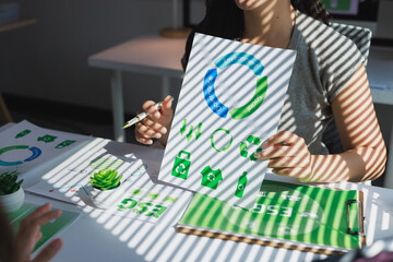 Businessperson holding document showing esg concepts and sustainability icons