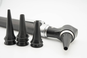 Otoscope isolated on white background for otolaryngologist or ENT physician doctor examining senior patient ear, hearing loss problem.