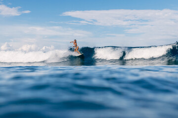 Surfer on surfboard during surfing. Surfer woman and ocean wave