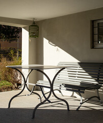 Detail of a typical Swiss porch on a house in Lugano, Ticino. You can see a metal table with a beautiful green wooden bench. Nobody around