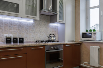 Modern Kitchen Interior with Gas Stove, Oven and Microwave