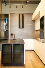 Modern kitchen featuring a sleek black gas oven and wooden cabinets