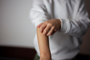 Dermatology with allergy, allergic reaction from atopic, insect bites on hand, hand scratching itching, red spot or rash on skin. Healthcare, beauty treatment background.