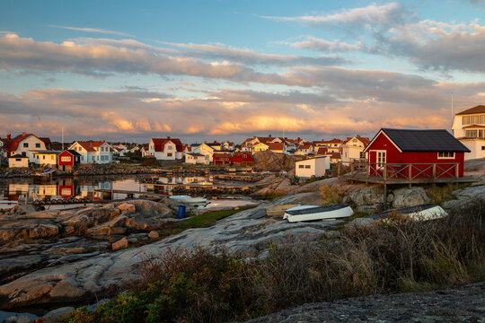 Vrango, Sweden - 09-08-2025 A beautiful summer sunset over the island Vrango in the Gothenburg archipelago with a view on fishing cabins hiding behind a pier of big rocks to protect them from the tide
