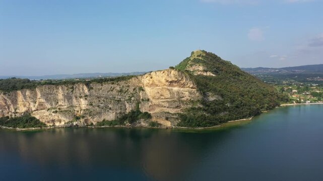 Aerial view of Rocca di Manerba on Lake Garda, Italy. Medieval ruins and fortress cliffs in sunny summer light.