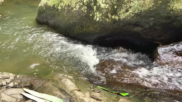 Water Stream Flowing Into Rock Crevice