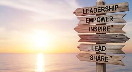 Wooden Directional Sign on Beach Emphasizing Leadership, Empowerment, and Inspiration during Sunset or Sunrise.