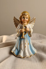 Fototapeta premium Vintage christmas figurine of a little angel with a trumpet