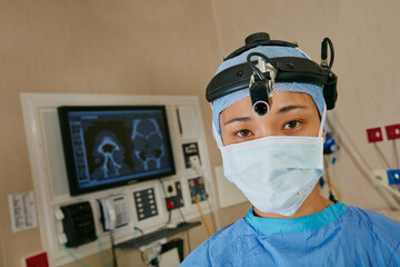 Portrait, woman and surgeon with headlight in theater for career pride, medical service and surgery...
