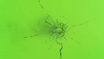 Freeze Motion Shot of Glass Shattered by a Bullet from a Pistol on Green Screen Background