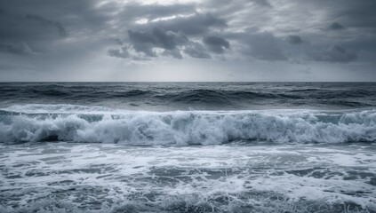 Dramatic ocean waves crashing under moody gray skies  