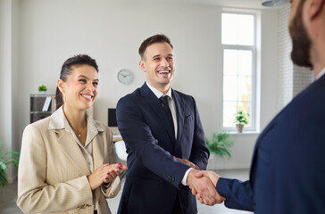 Business handshake shows teamwork during office meeting. Executives celebrate agreement and...