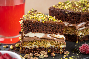Chocolate pistachio layer cake slice with cream filling
