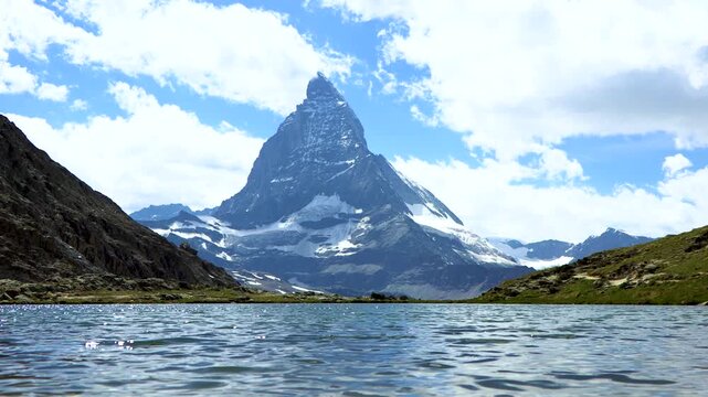 Stunning view of Iconic Matterhorn mountain with lake in the forefront 