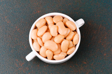 Plain white butter beans in bowl closeup for protein, diet or vegan food concept